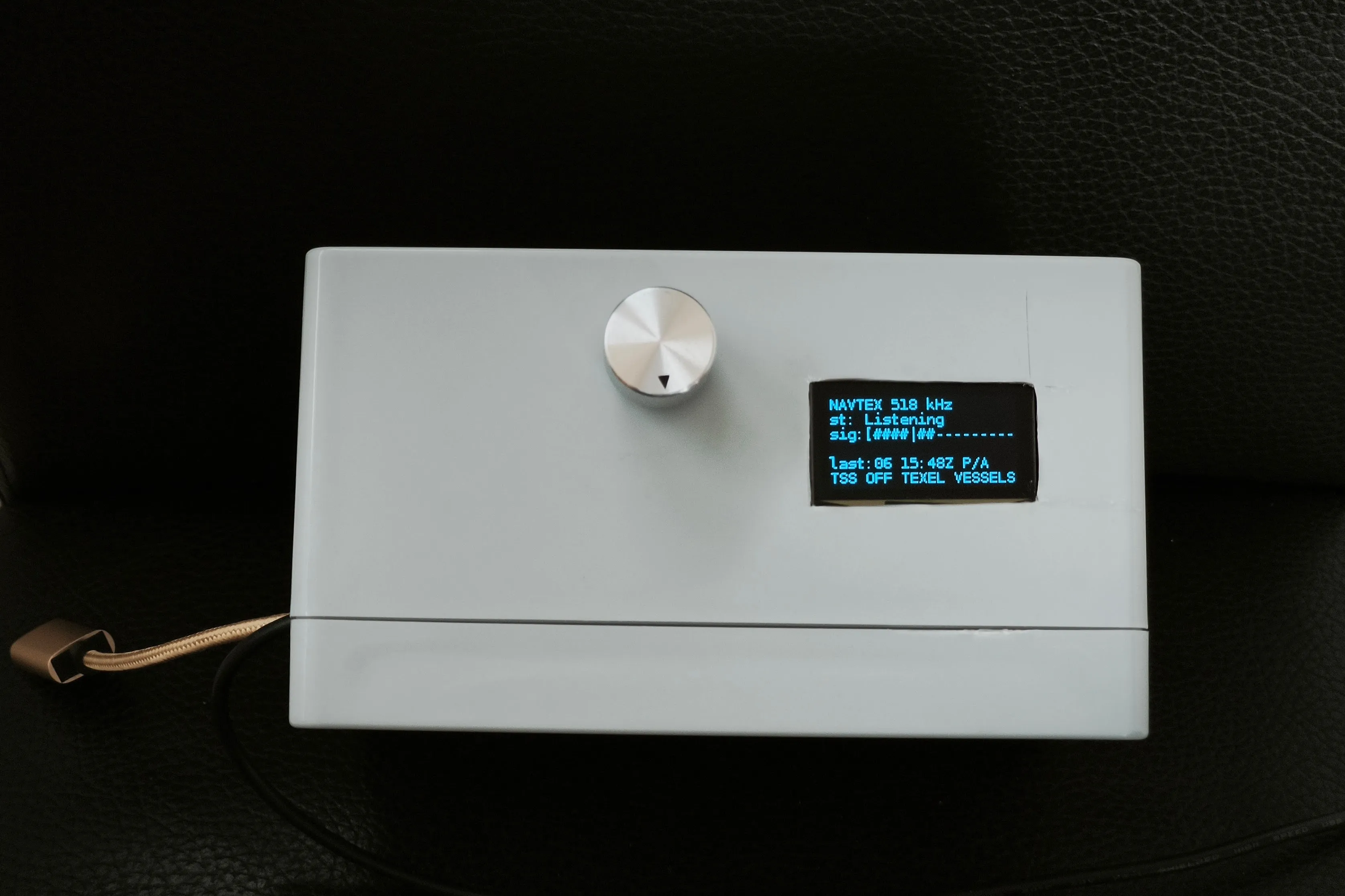 The Raspberry Pi Zero 2 W in a project box with a knob encoder and a small OLED display.